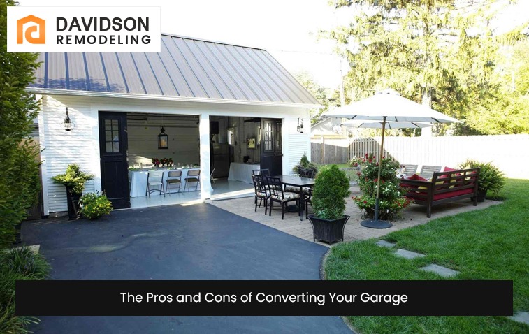 Exterior view of a converted garage featuring a beautiful backyard with paving and patio seating